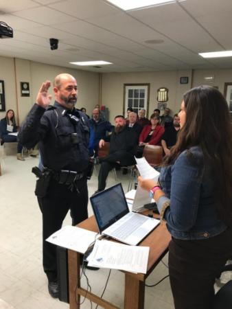 City Clerk Lesley Shook swears in Patrick Shook to the Arkansas City Police Department.  